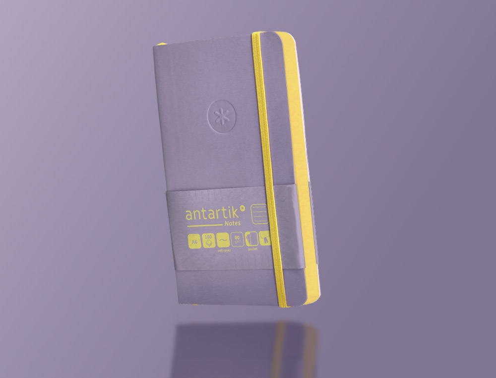 CUADERNO CON GOMILLA ANTARTIK NOTES TAPA BLANDA A6 RAYAS MORADO Y AMARILLO 100 HOJAS 80 GR FSC